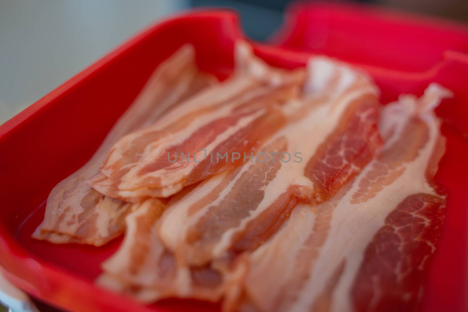 The sliced raw pork meat isolated on white background. Top view.
