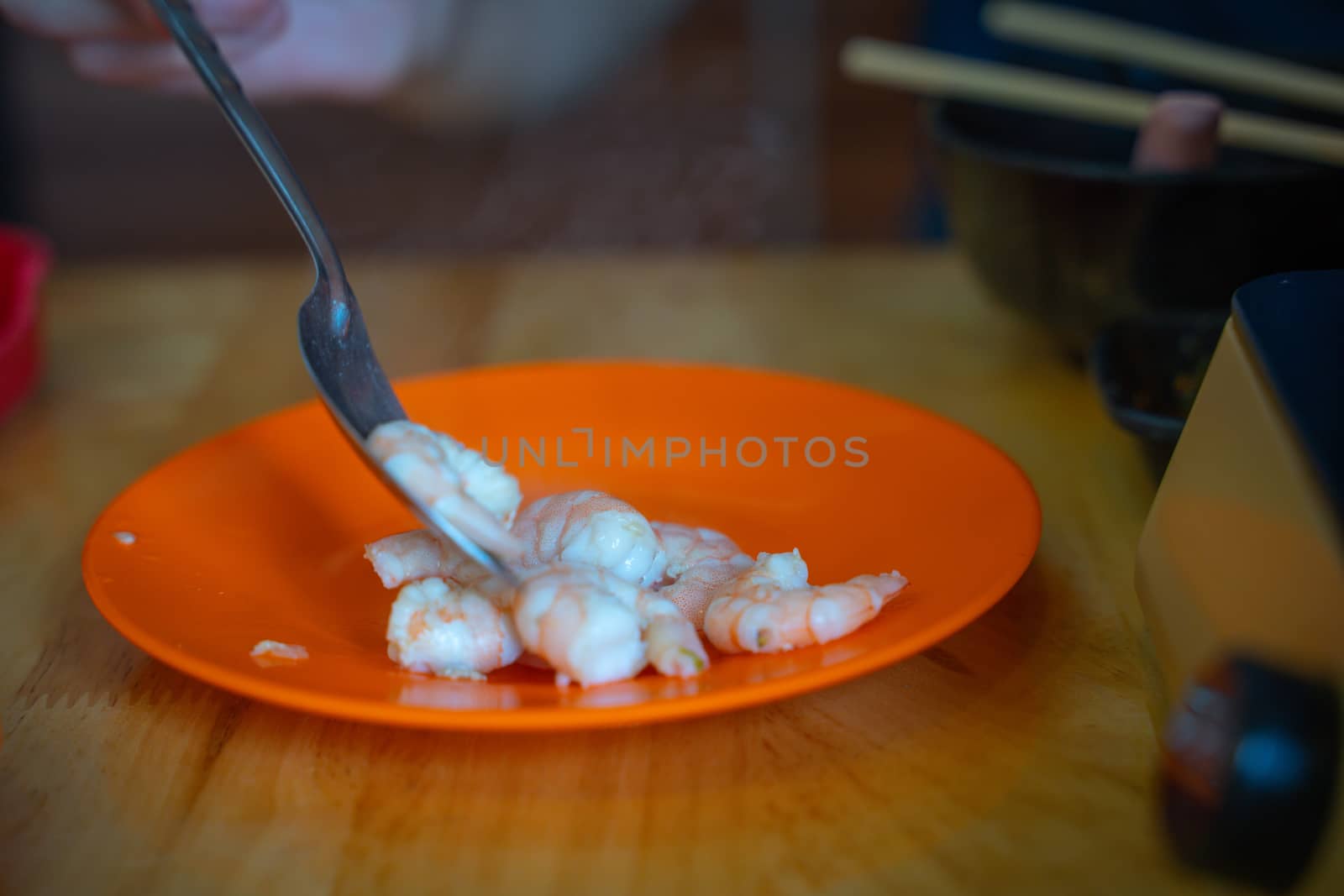 The Raw whole fresh uncooked prawns shrimps on stone red plate