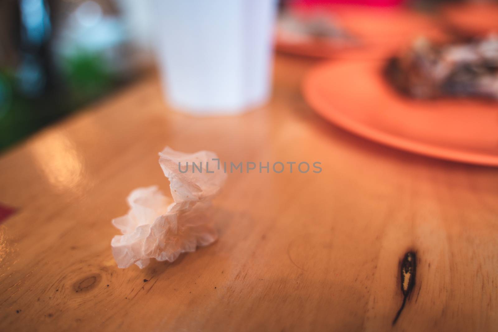 Used Tissue on the food table with blur background by peerapixs