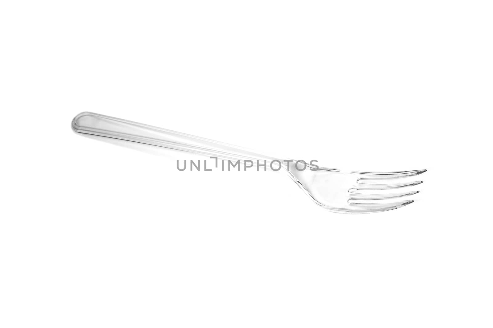 Transparent plastic fork isolated on white background. Close up