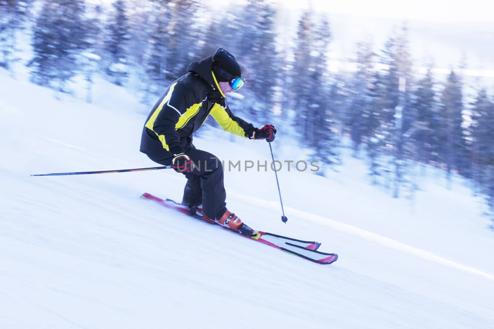 Skier in mountains, prepared piste and sunny day