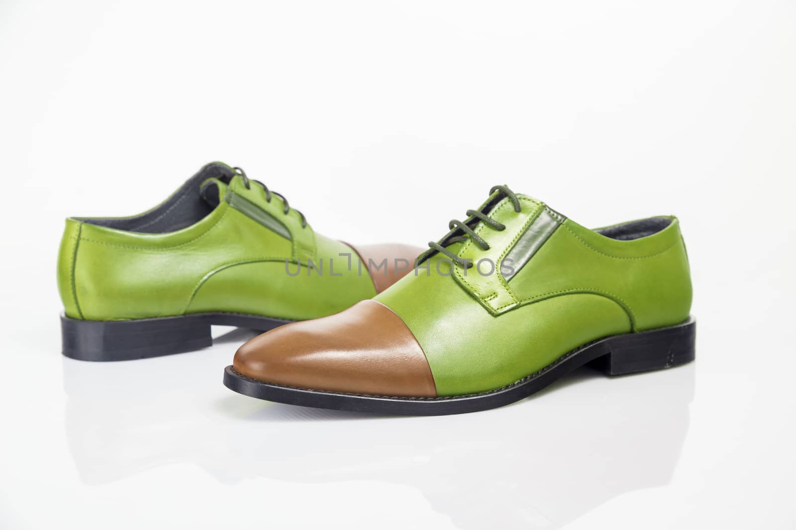 Male green and brown leather shoe on white background, isolated product. by GeorgeVieiraSilva