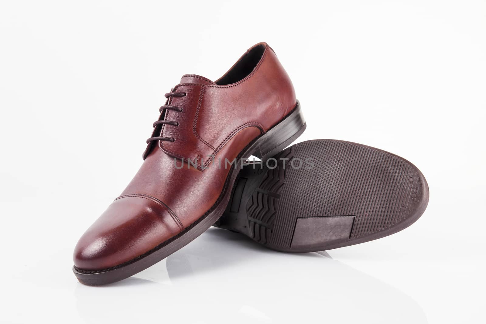 Male red leather shoes on white background, isolated product. by GeorgeVieiraSilva