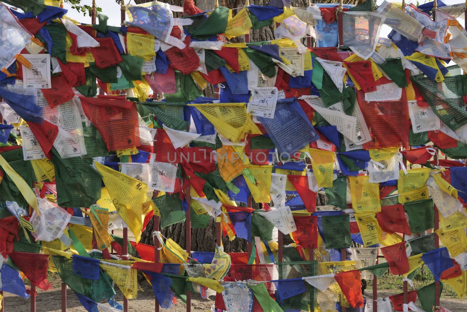 Multicolored prayer flags on the background of Buddhist stupas. Old Hurul in Kalmykia, Russia.