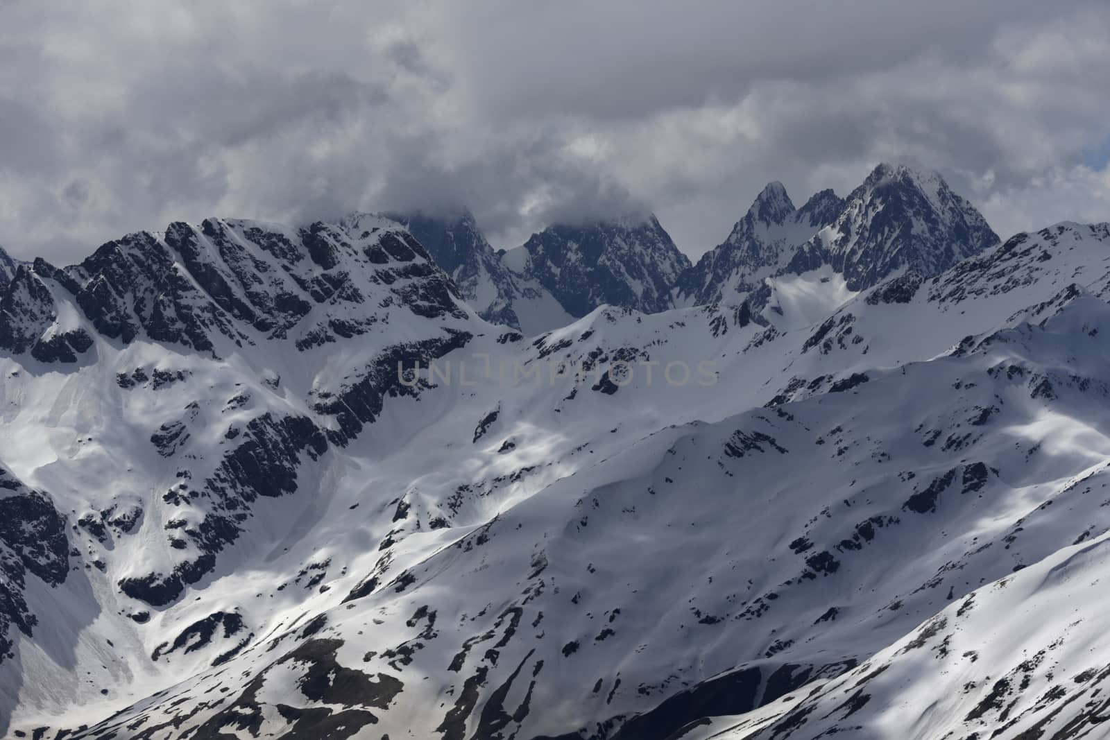 View of Snow Mountain Range Landscape with Blue Sky. Russia, Caucasus.