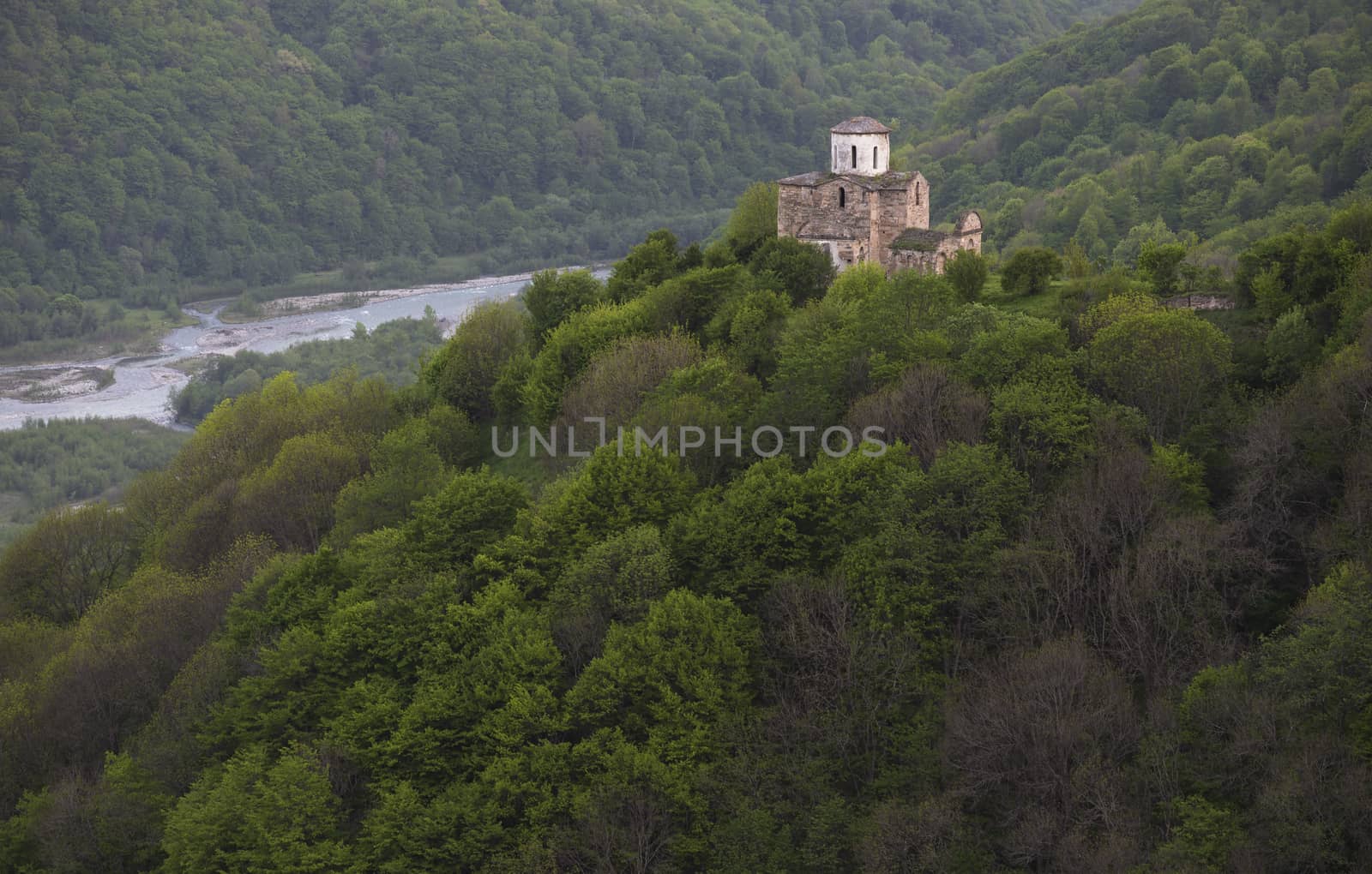 mountains covered by forest and old church 10 century 