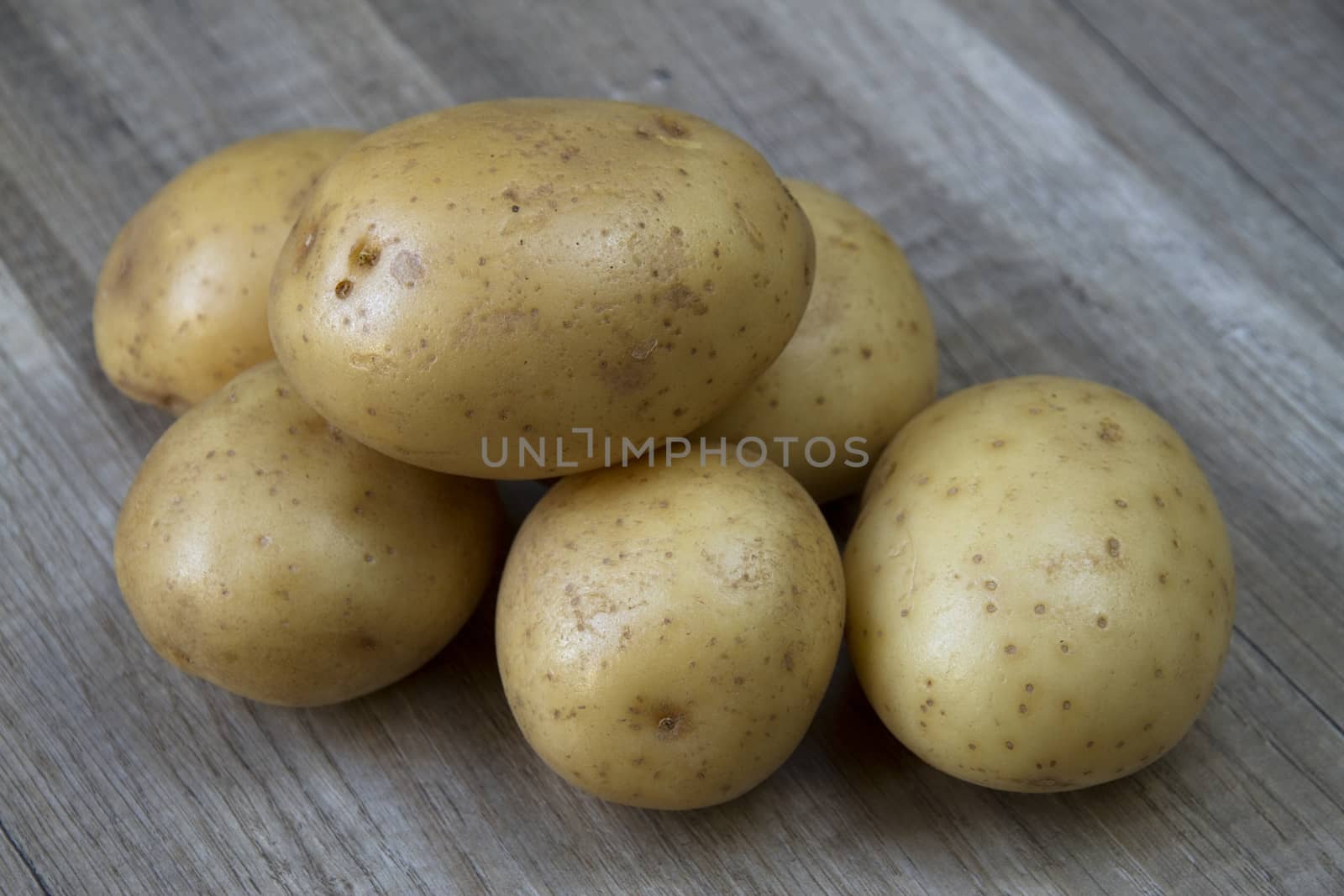 potatoes on an old wooden background