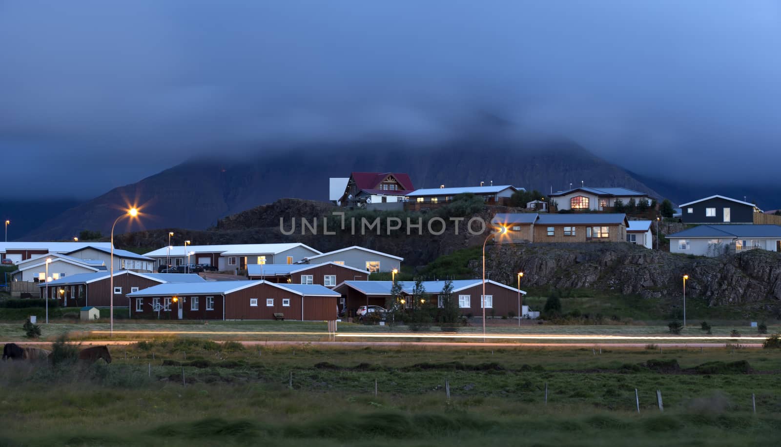 Small icelandic village in the foot of volcano at night 