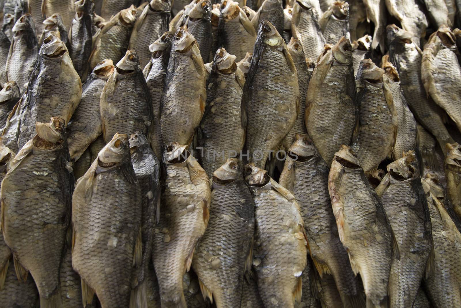 Dried fish on the table. Salty dry river fish as background, top view.