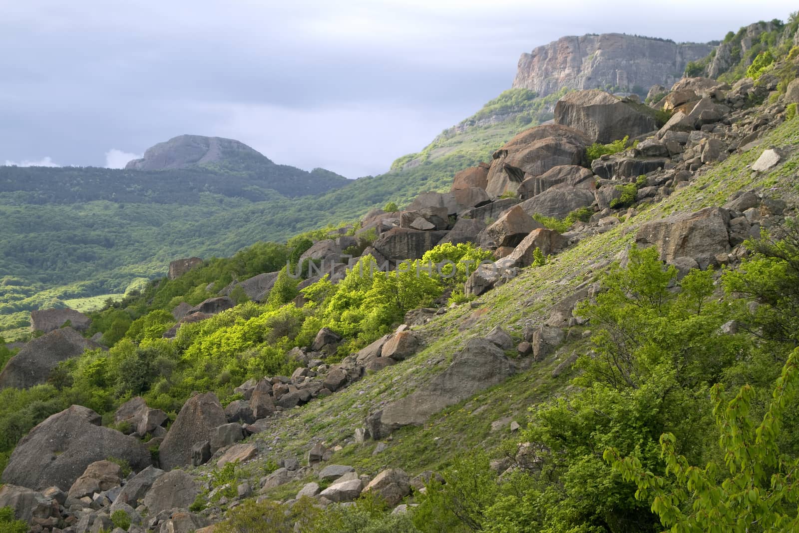 mountain landscape, rock and stone chaos, against the cloud  sky