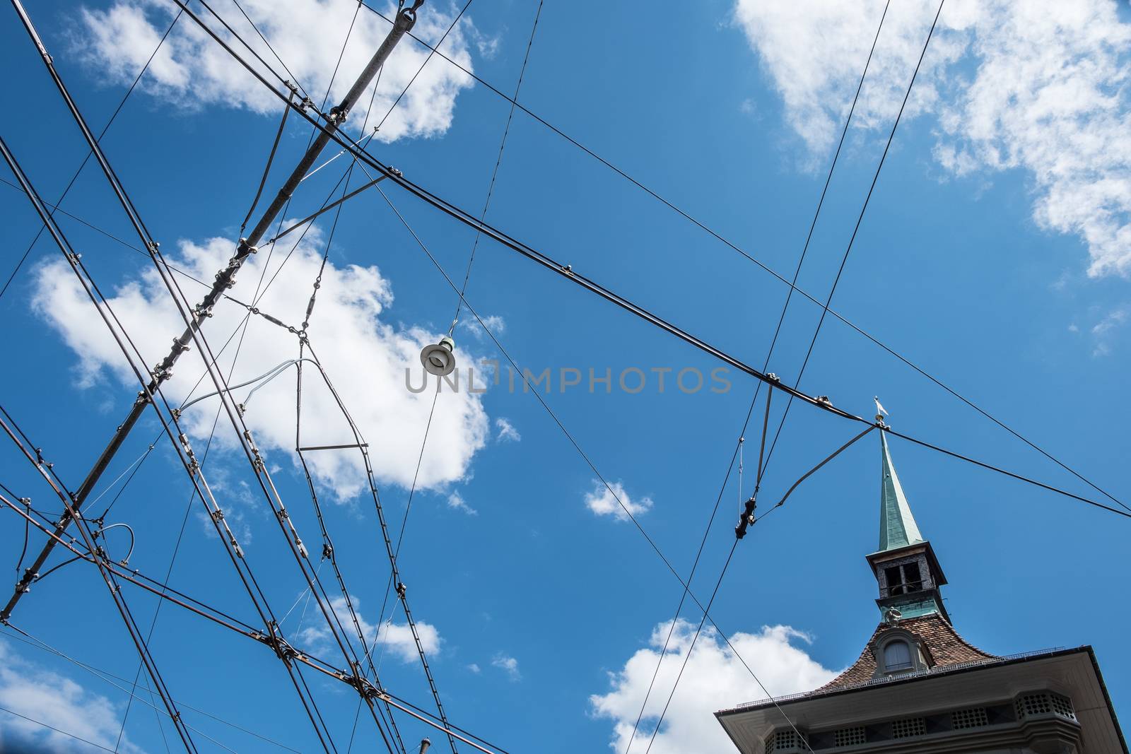 Power lines for street cars with blue sky in Bern