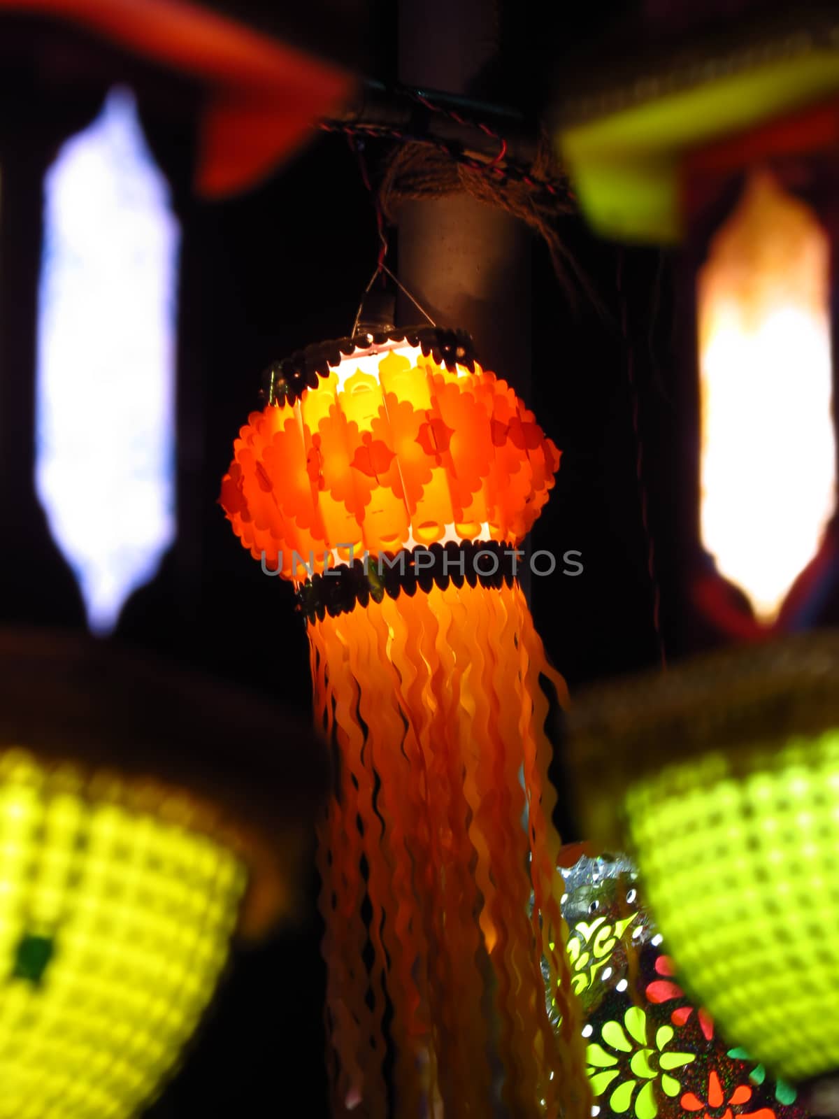 An orange traditional Diwali lantern hanging on an old pole during Diwali festival in India.                               