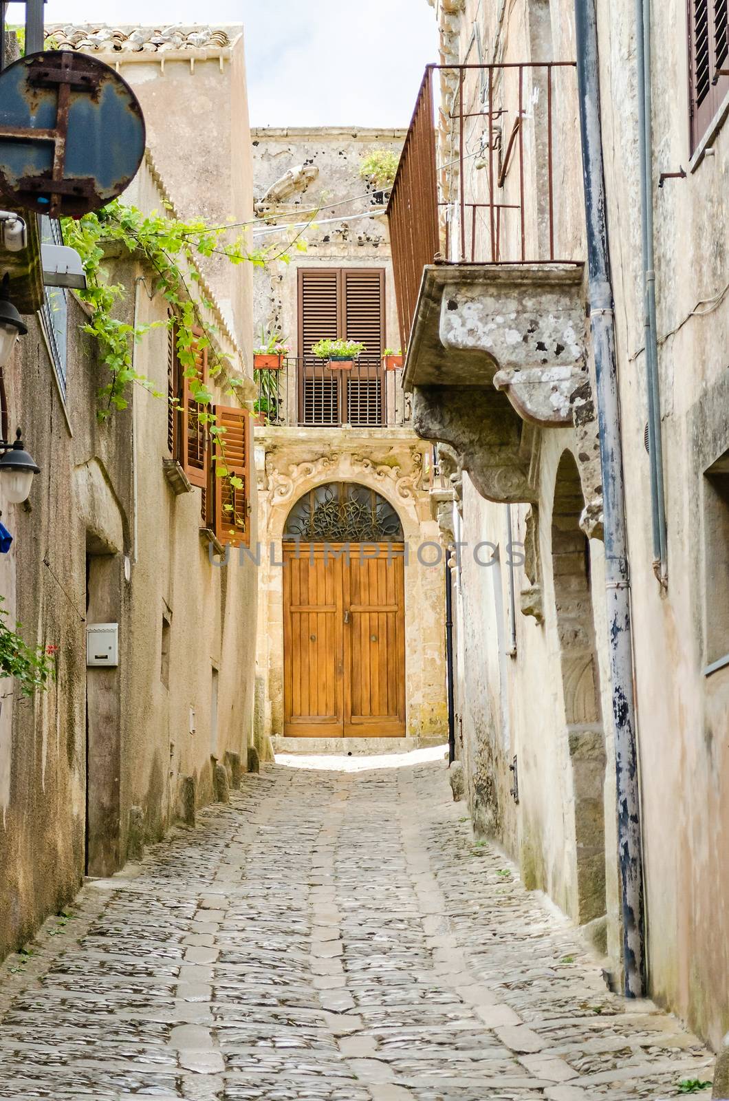 Stone paved ancient medieval street in the town of Erice, Sicily, Italy