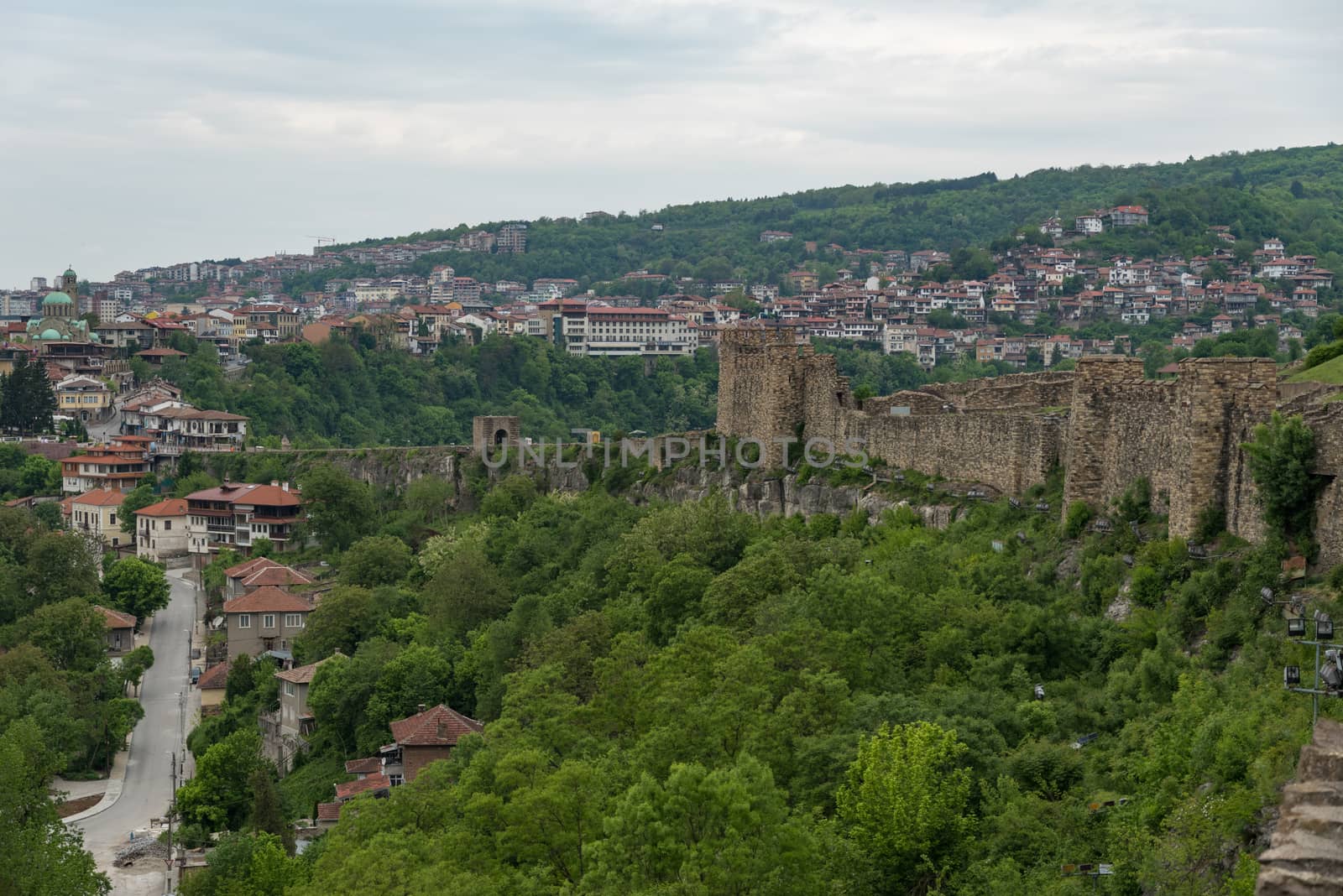 Veliko Tarnovo, Bulgaria - 8 may, 2019:  Gate tower and ruins of Tsarevets fortress with a view of the old town of Veliko Tarnovo in the background, Bulgaria