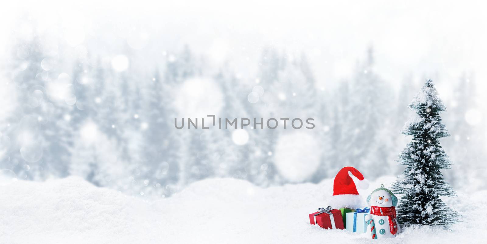 Snowman fir tree and christmas gifts on sleigh on snow, winter forest and white falling snow bokeh background