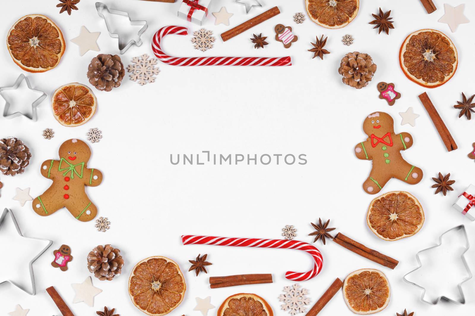 Christmas food frame. Gingerbread cookies, spices and decorations on white background with copy space