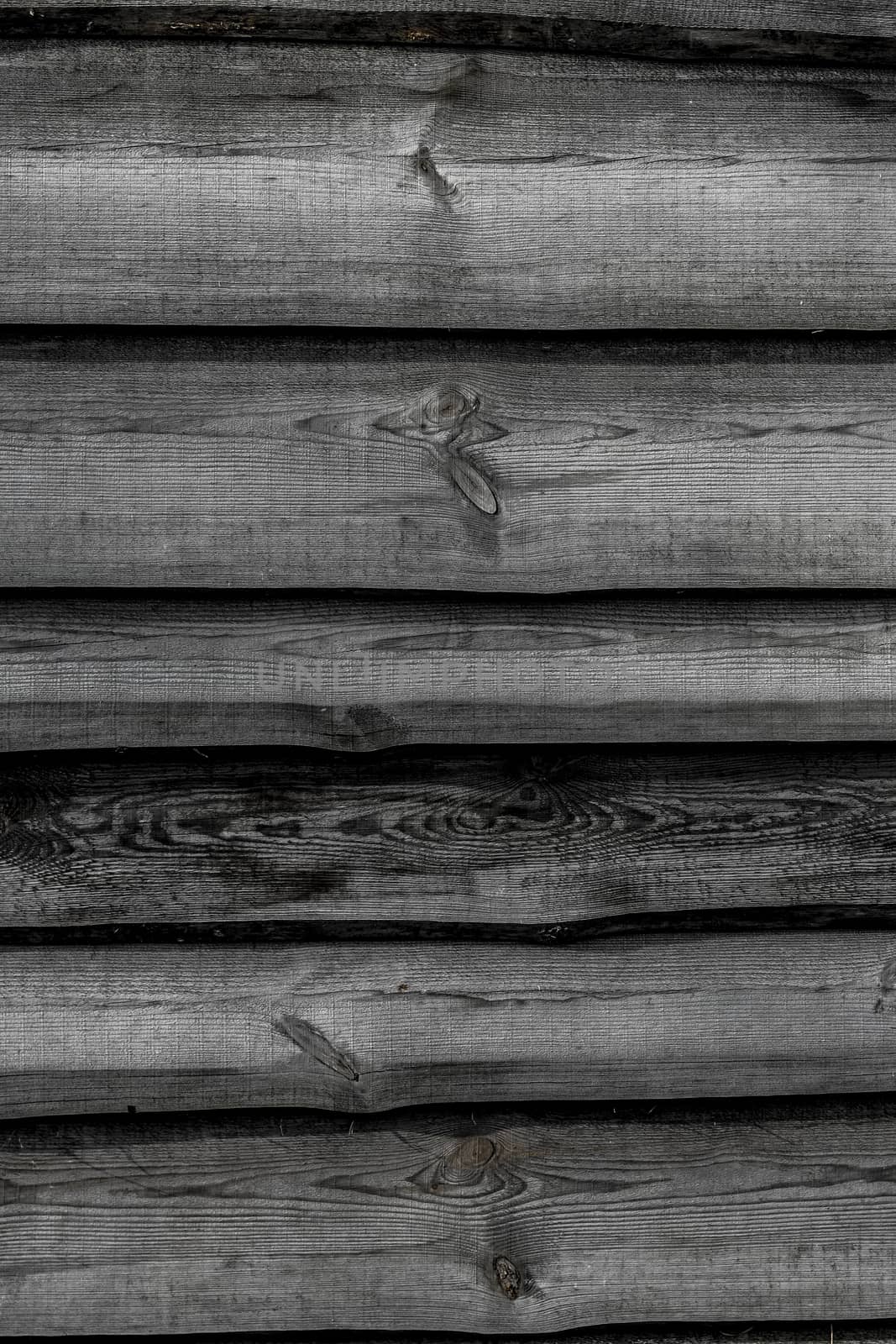 Black wooden boards vertical background. Wall floor or fence exterior design. Natural wood material backdrop