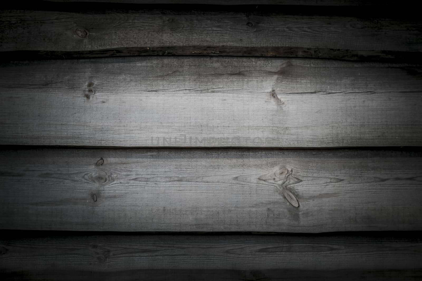 Old gray boards background in dark. Wall floor or fence exterior design. Natural wood material backdrop