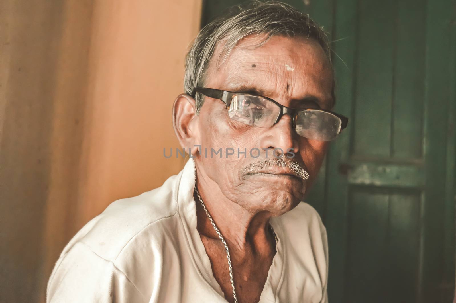 Portrait of an Active senior retired Asian and Indian Ethnicity man of 73 years old standing and looking at camera.