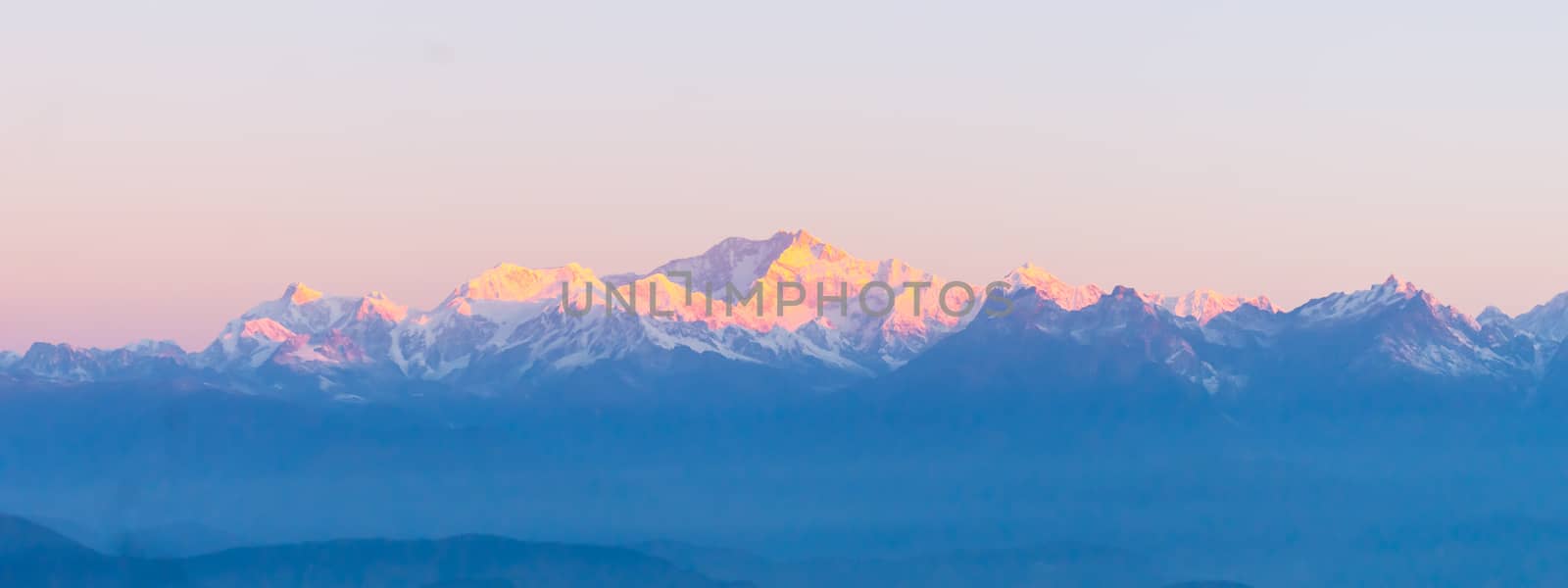 Panorama of majestic Mount Kanchendzonga range of himalayas at first sunrise from Tiger Hill. First ray of sun struck mountain starting beautiful day on entire nature around. Darjeeling, Sikkim, India by sudiptabhowmick