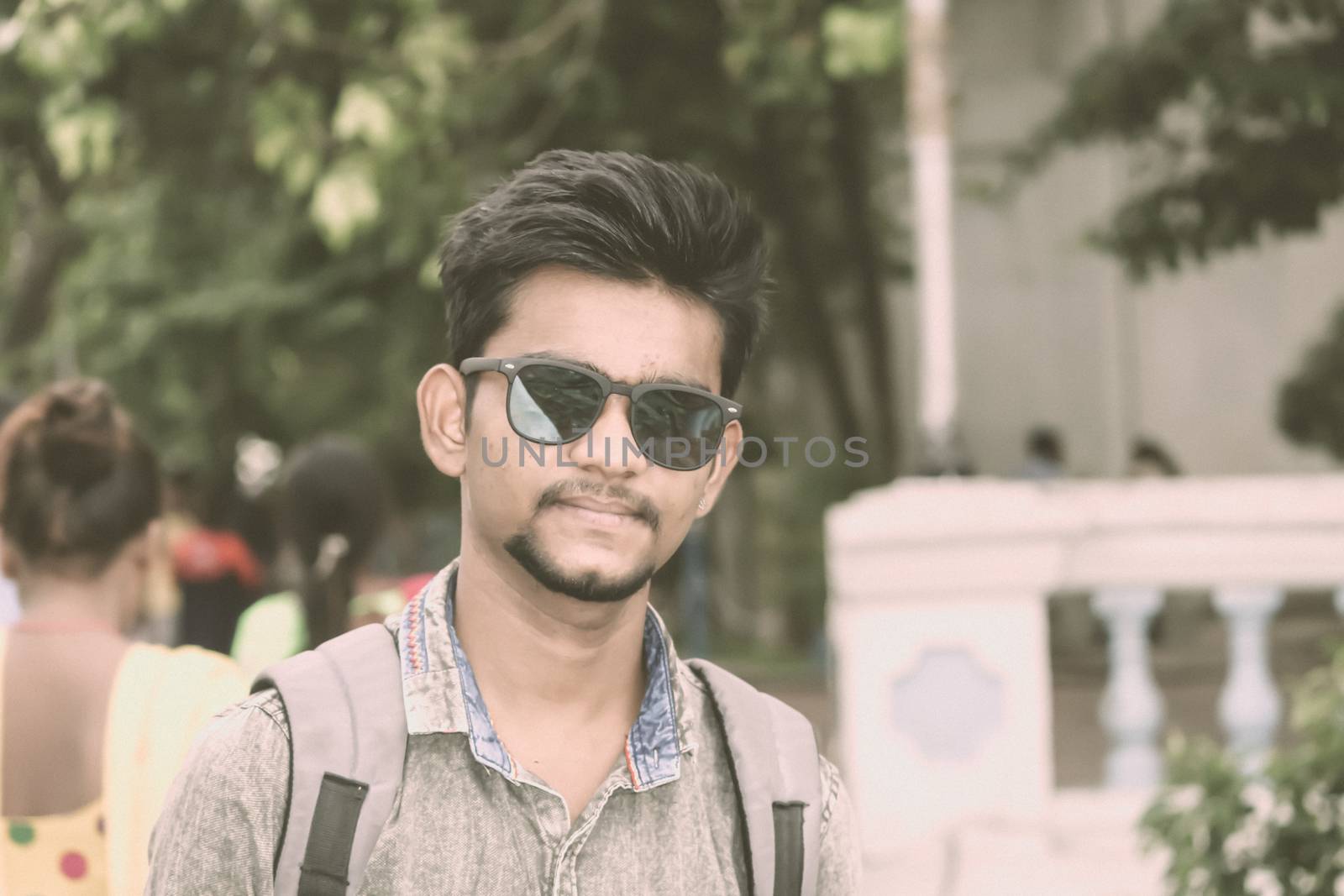 Half length portrait of attractive young a man called Ove standing outdoors outside college building and looking at camera. A High school student portrait photography on 15 October World Students Day. by sudiptabhowmick