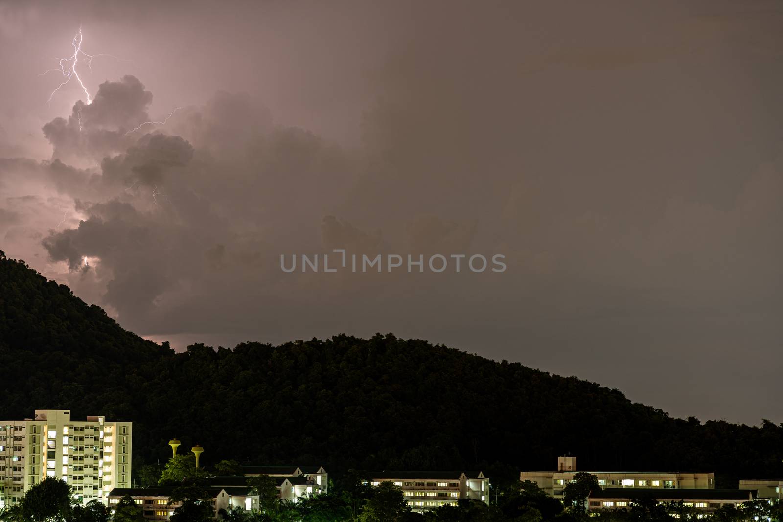 The Storm lightning strikes in mountains during a thunderstorm at night. Beautiful dramatic view