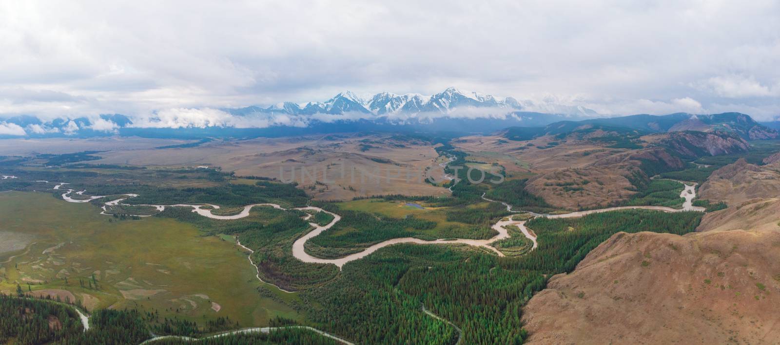 Panorama of Kurai steppe and Chuya river on North-Chui ridge background. Altai mountains, Russia. Aerial drone panoramic picture.