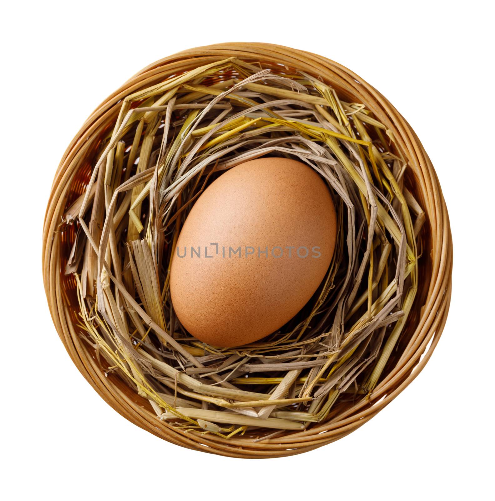 Chicken or hen egg on straw in wicker basket isolated on white background