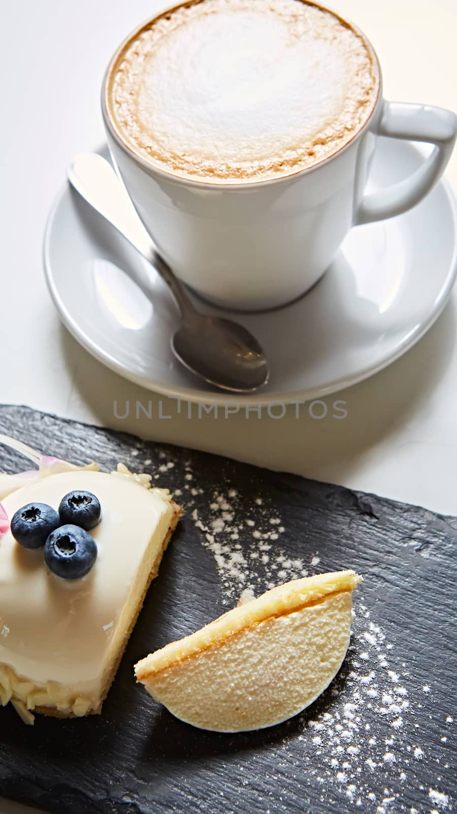 Vanilla bavarian mousse cake with cherries and dark chocolate on top. Made with cream cheese and whipped cream.