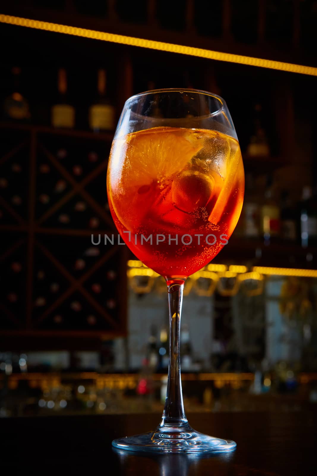 Aperol Spritz Cocktail Alcoholic beverage based on bar counter with ice cubes and oranges.