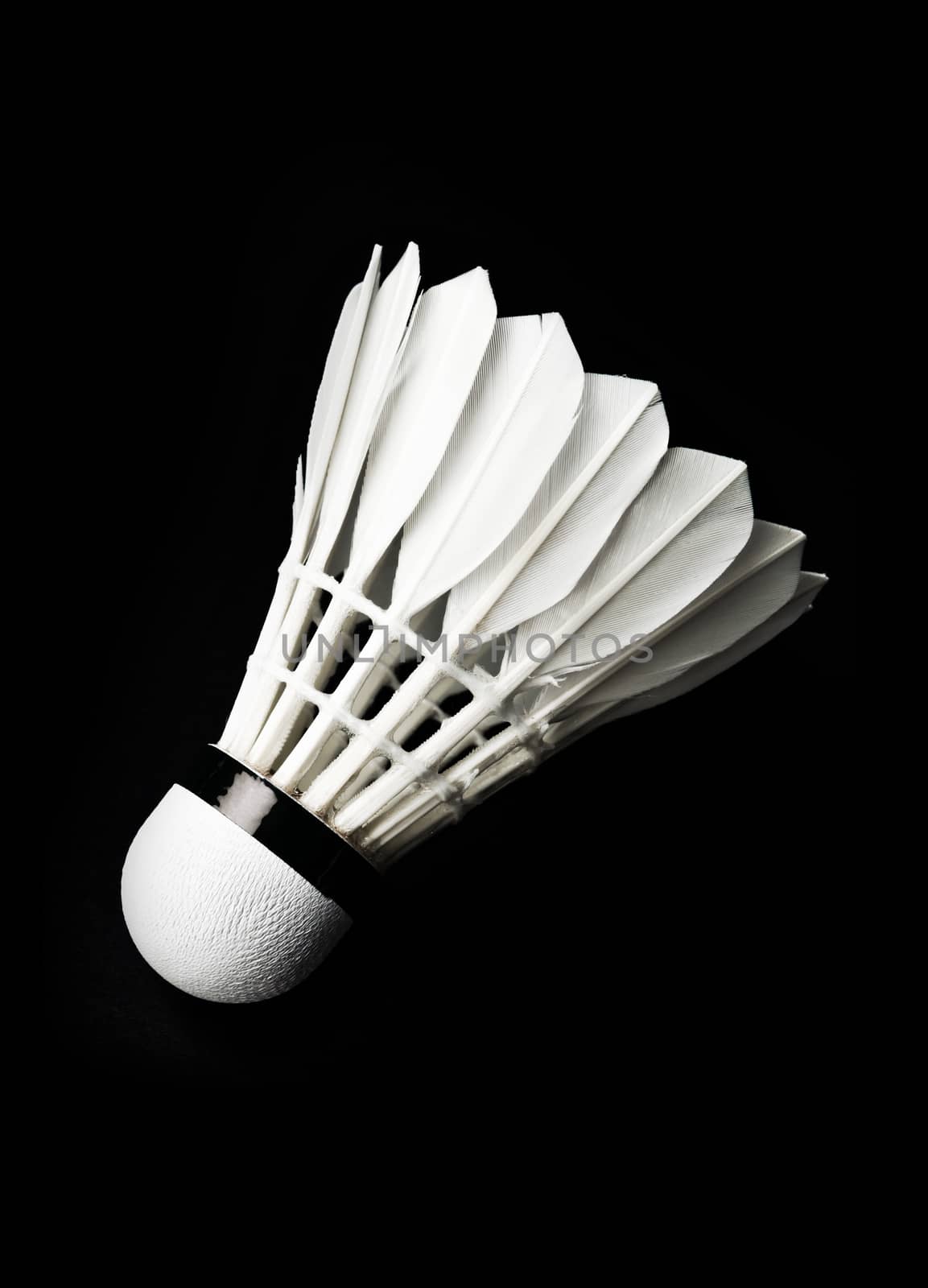 Badminton shuttlecock on black background. by Gamjai