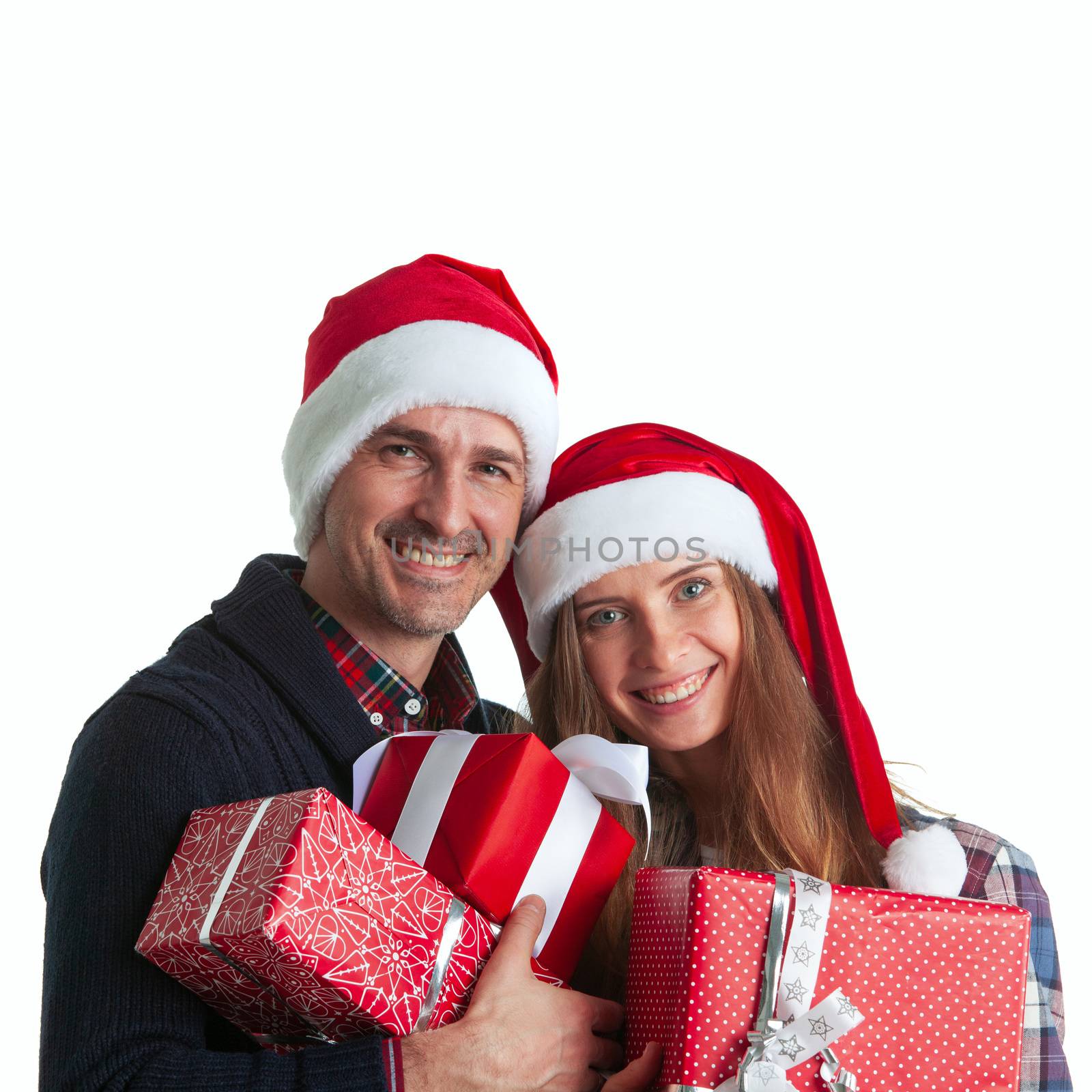 Happy beautiful couple holding many christmas gifts isolated on white background