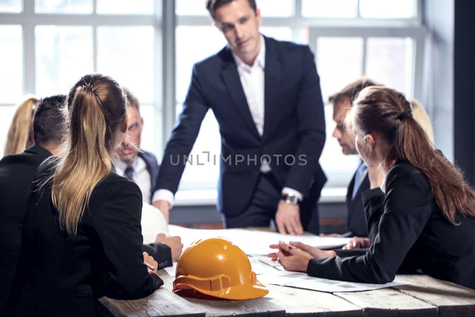 Engineers and businessmen are discussing construction projects in workplace. Construction concept.