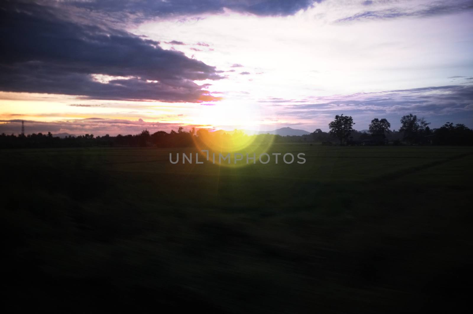 A colorful sunup above a small train station in thailand , Effect lens flare