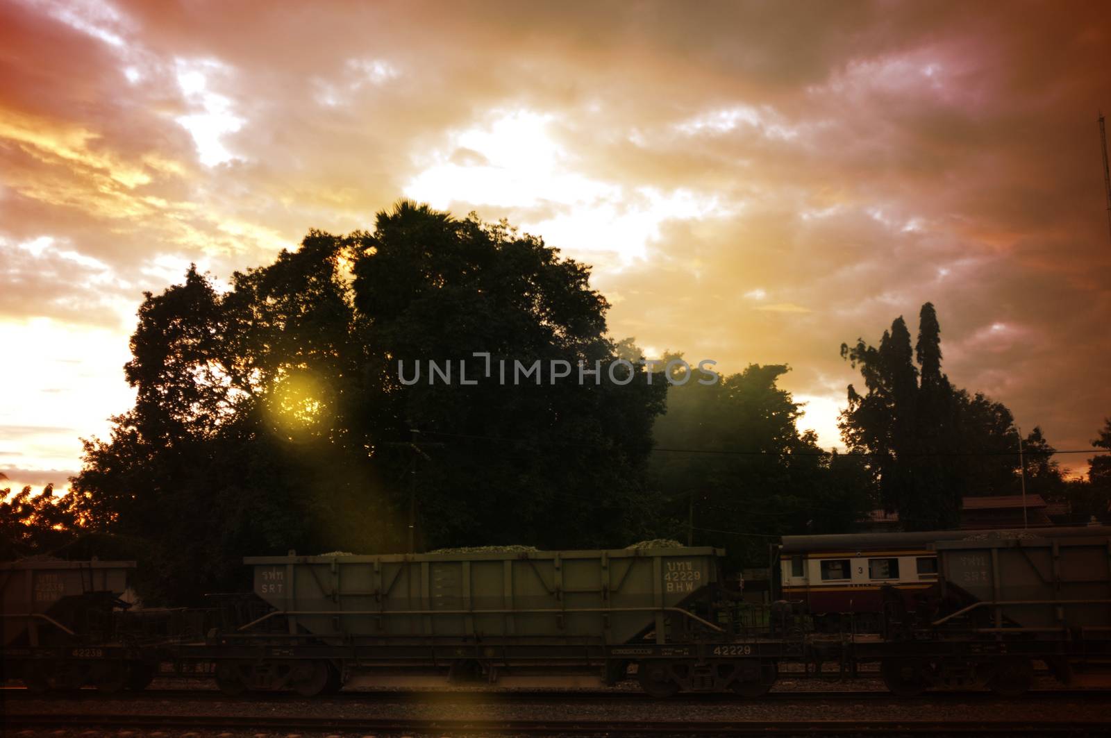 A colorful sunup above a small train station in thailand 