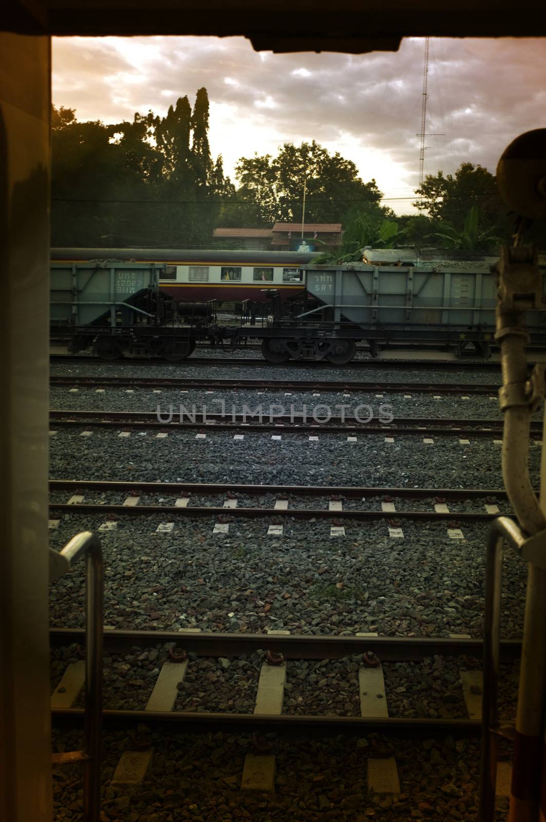 A colorful sunup above a small train station in thailand 