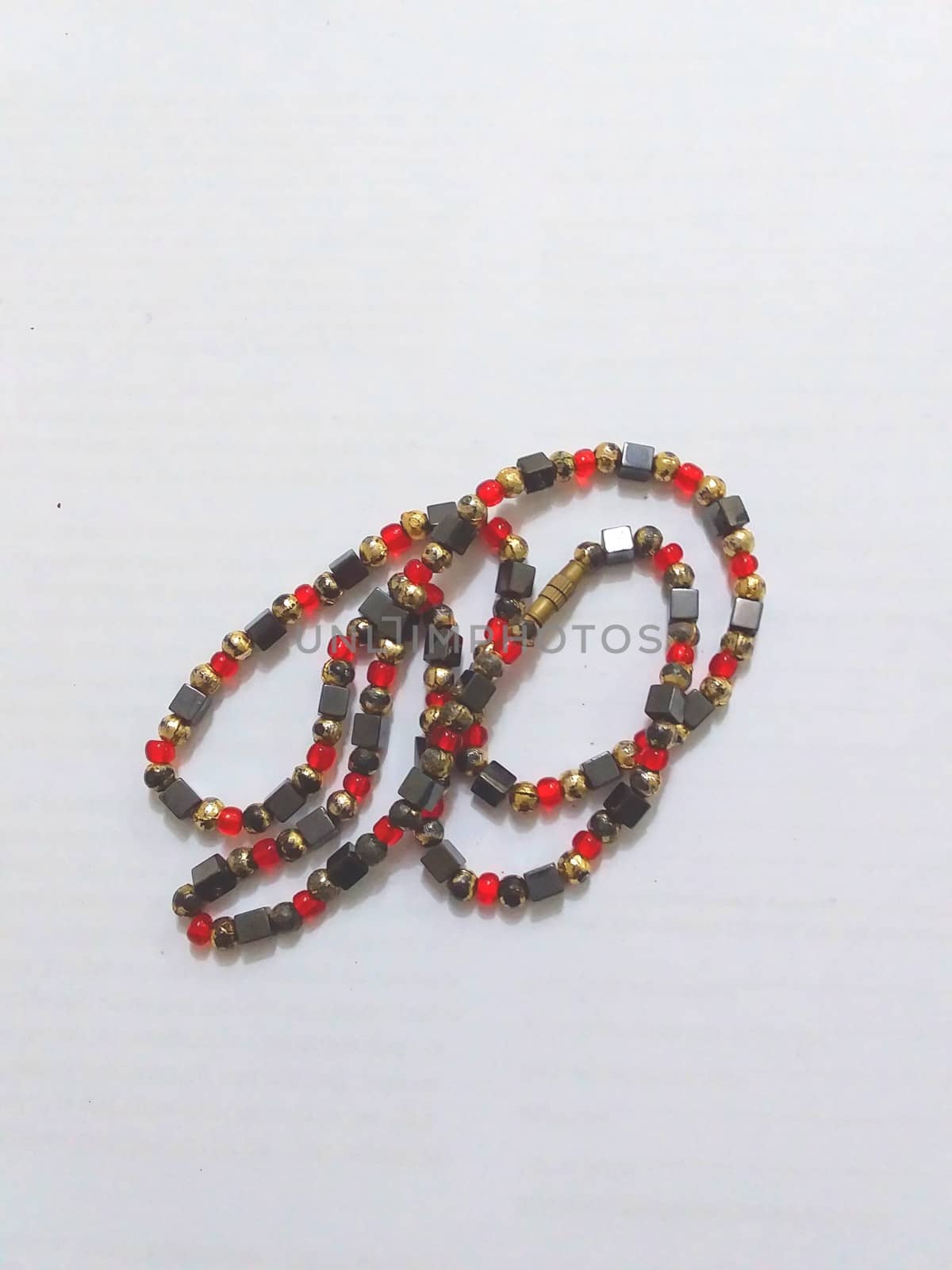 a necklace with red and green beads