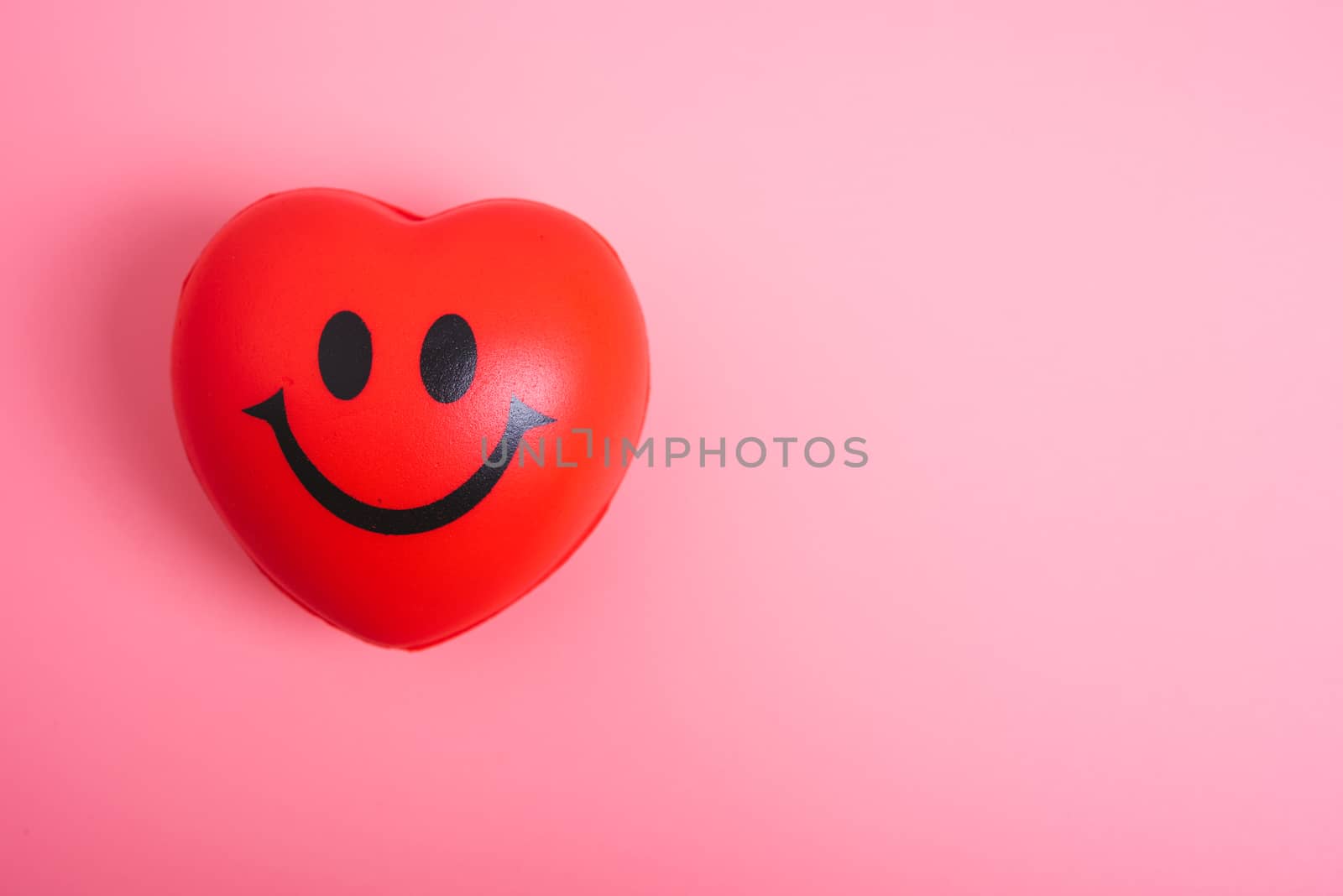 Red heart on pink background with copy space, valentine day concept