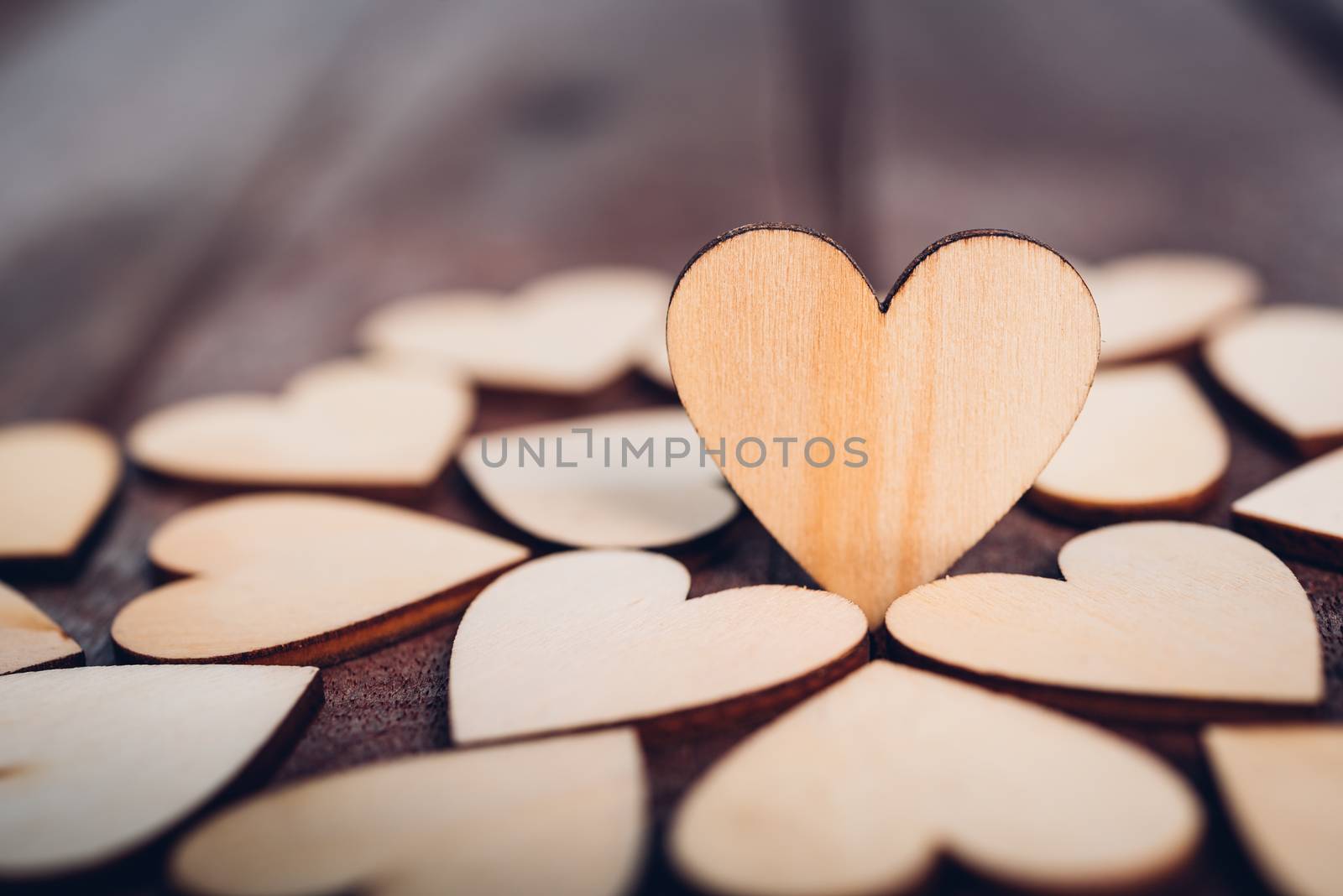 Wood heart stand on wooden background by Sorapop