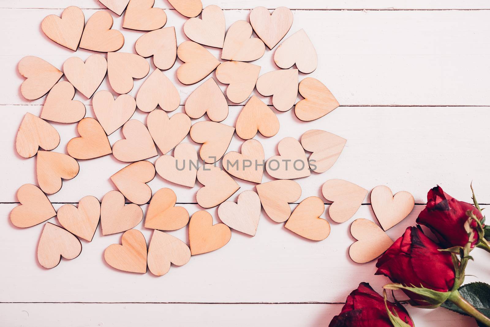 Wood hearts and red roses on white wooden background have frame copy space, valentine day concept