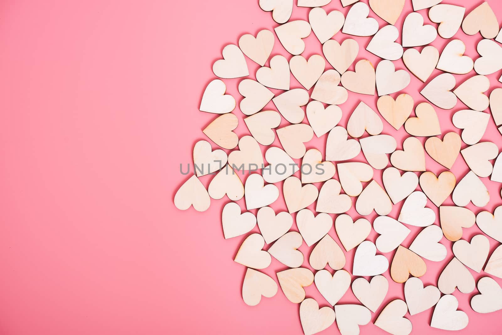 Wood hearts on pink background with copy space, valentine day concept