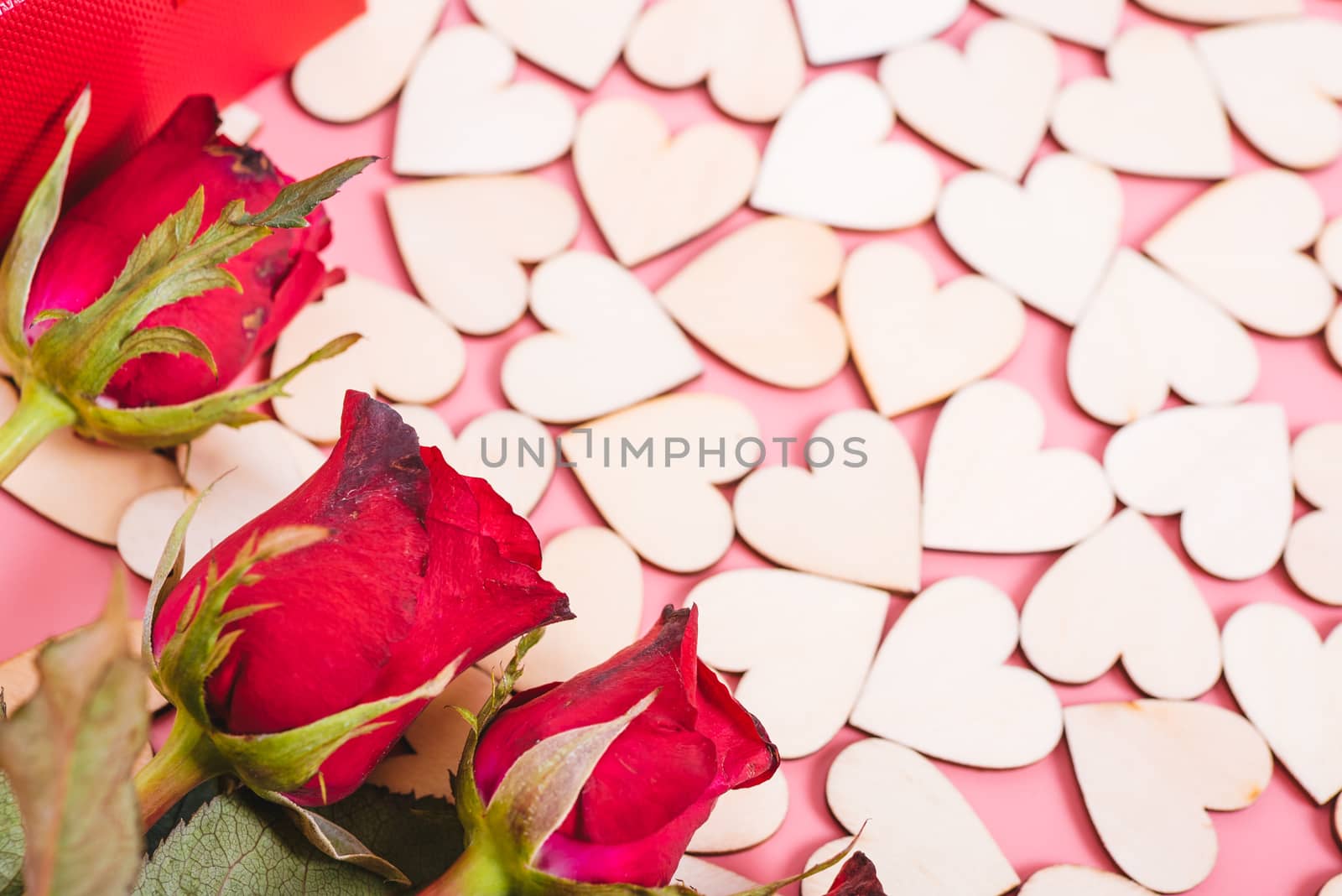 Wood hearts on pink background have a flower rose, valentine day concept