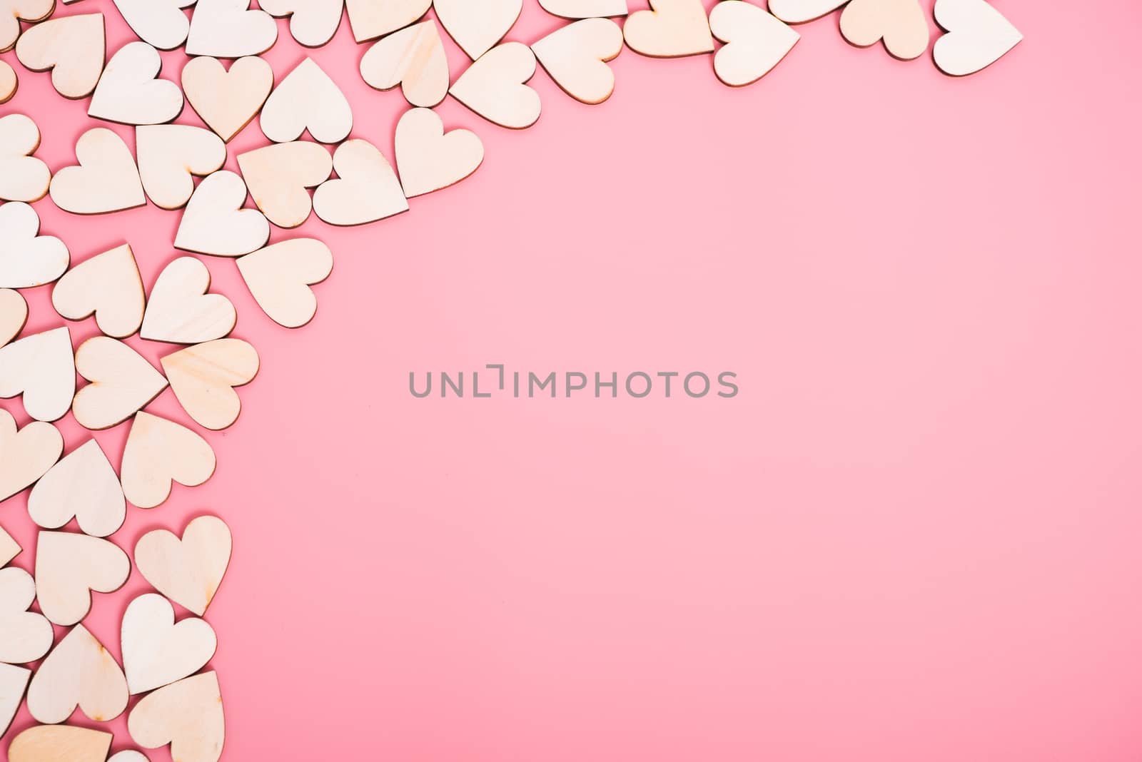 Wood hearts on pink background with copy space, valentine day concept