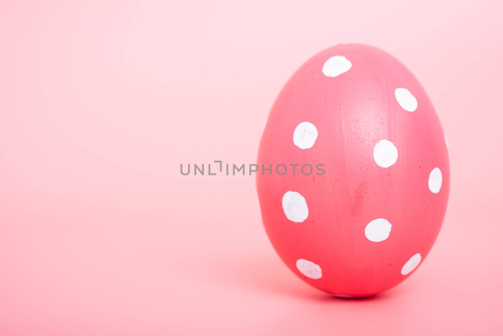 Beautiful Easter Pink egg color on pink background, Easter day concept