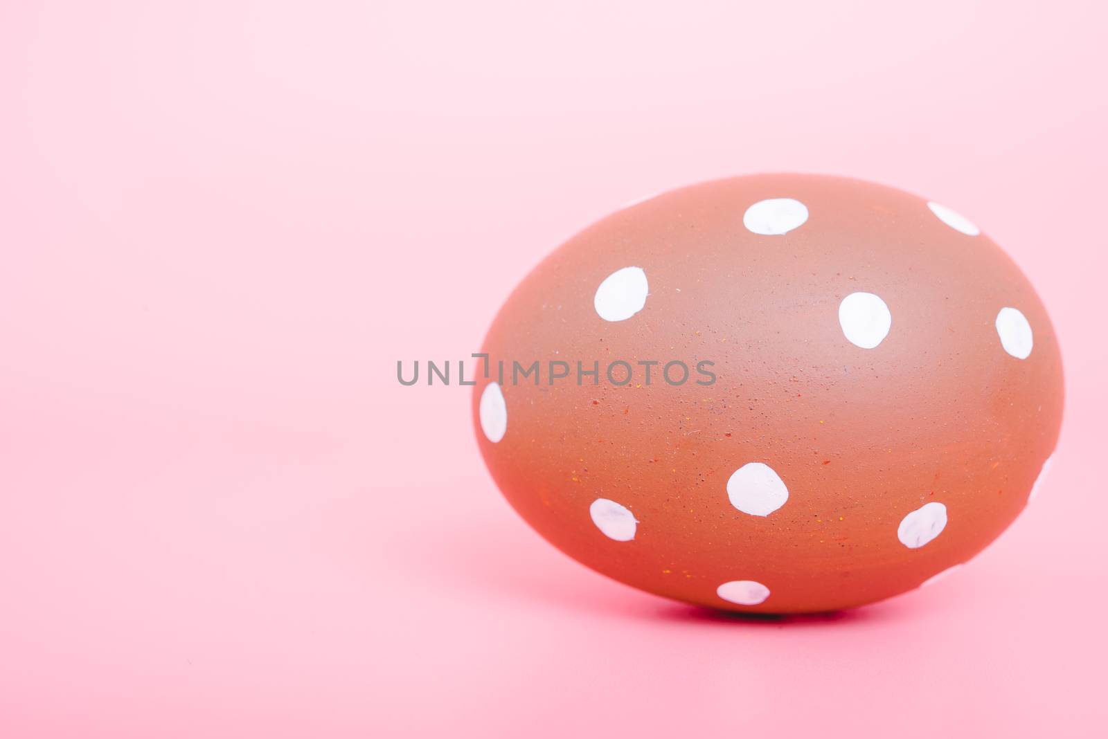 Beautiful Easter Brown egg color on pink background, Easter day concept