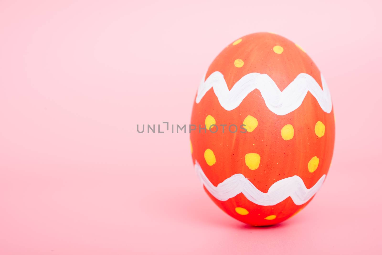 Beautiful Easter Red egg color on pink background, Easter day concept