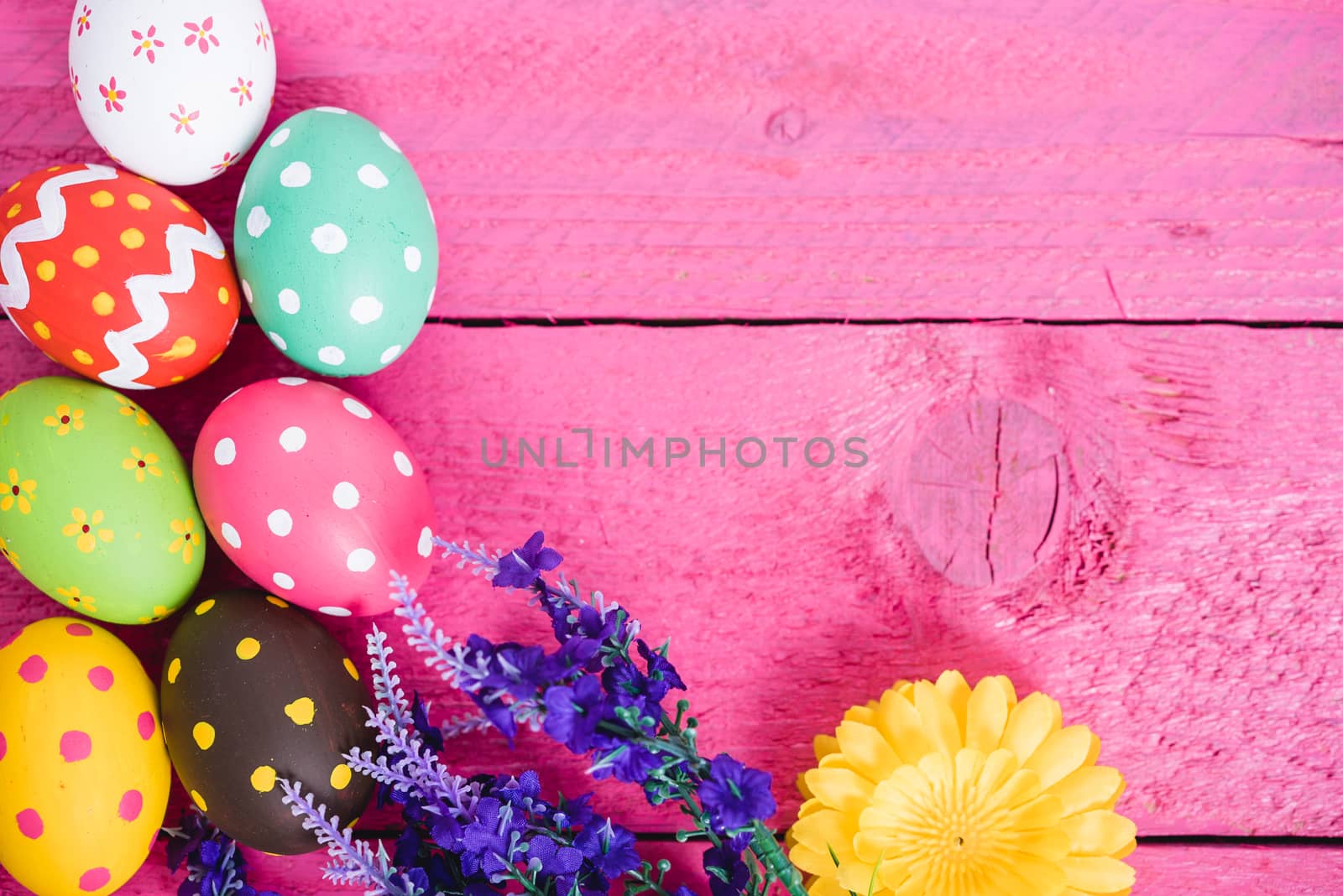 Easter eggs top view on pink wooden background and have copy space for use