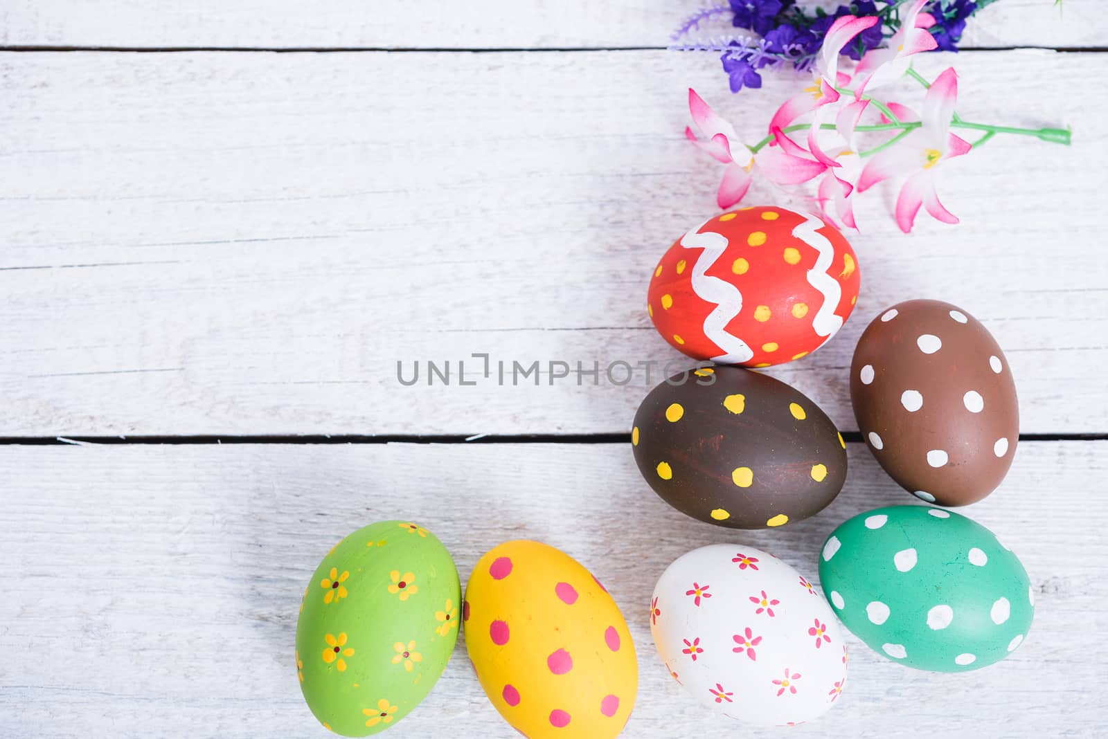 Easter eggs top view on white wooden background and have board work space board for use
