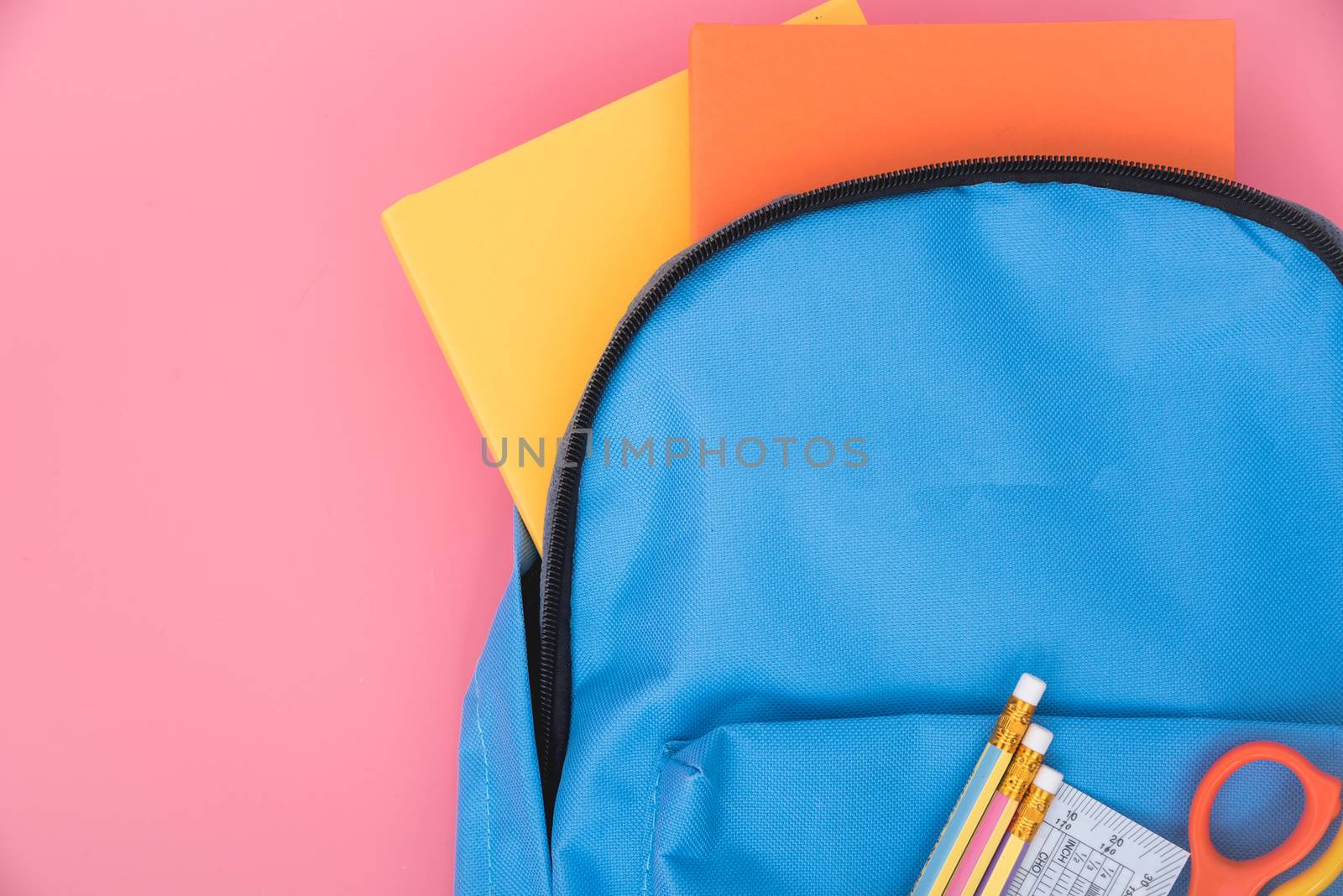 Blue bag backpack for education children on pink background back to school concept