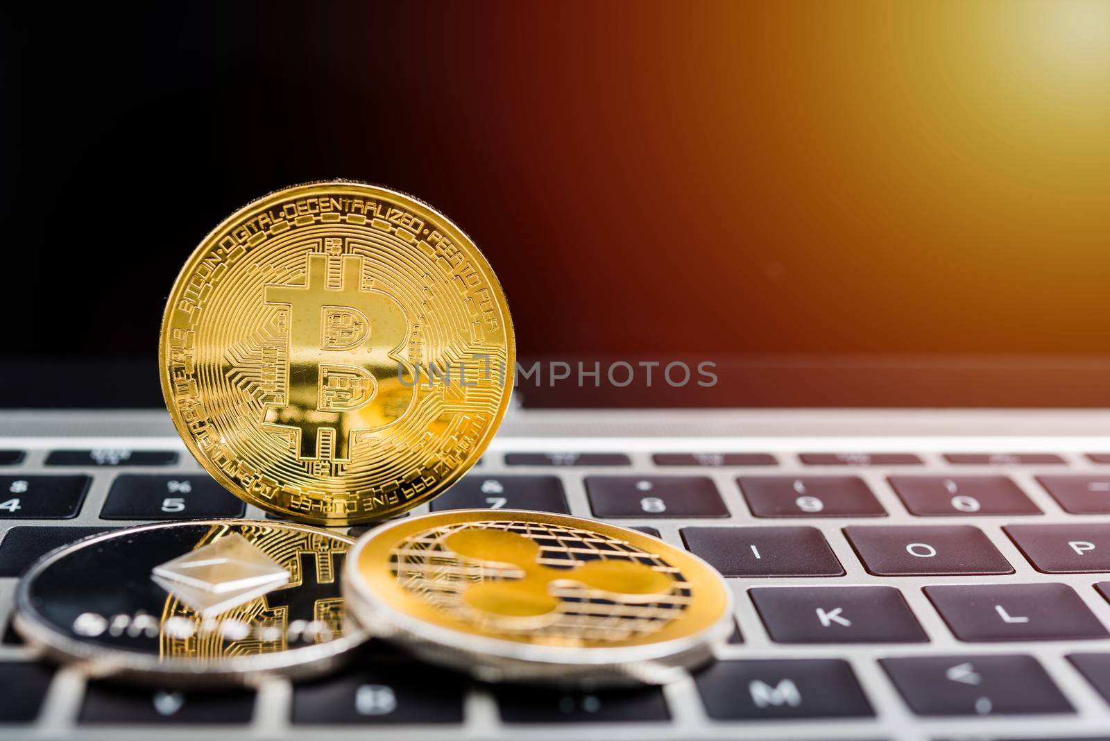 Virtual golden Bitcoin coin currency finance money on computer laptop keyboard